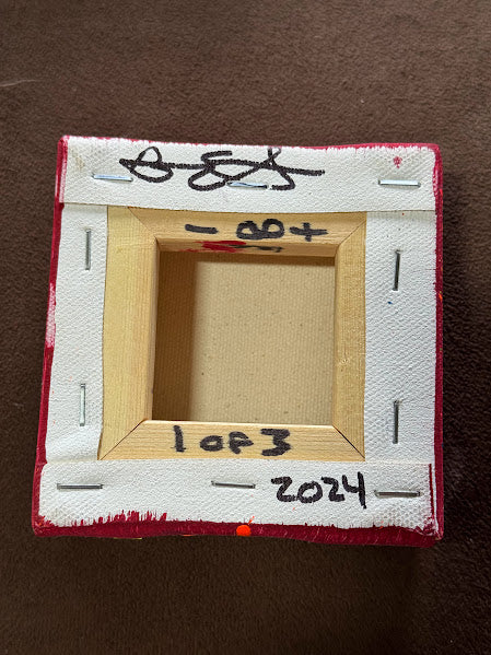 Small wooden frame with white border and text on a brown background